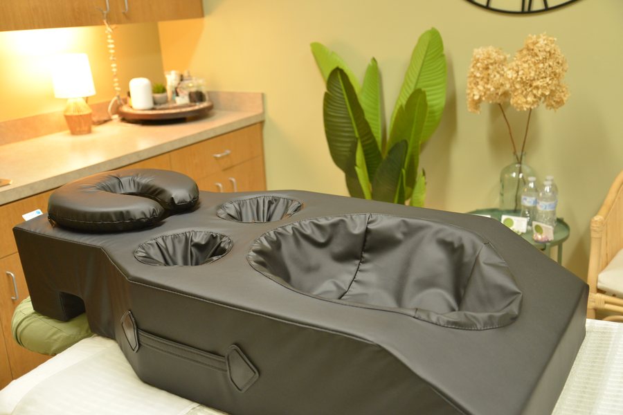 The prenatal cushion set up on the massage table