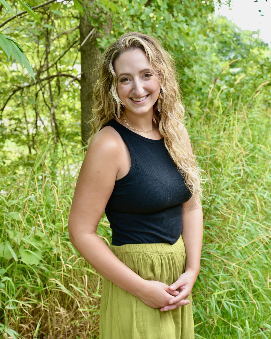Sarah Ahrens outdoors in tall green grass